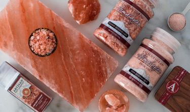 Himalayan salt in packaging and bowls on a himalayan slab